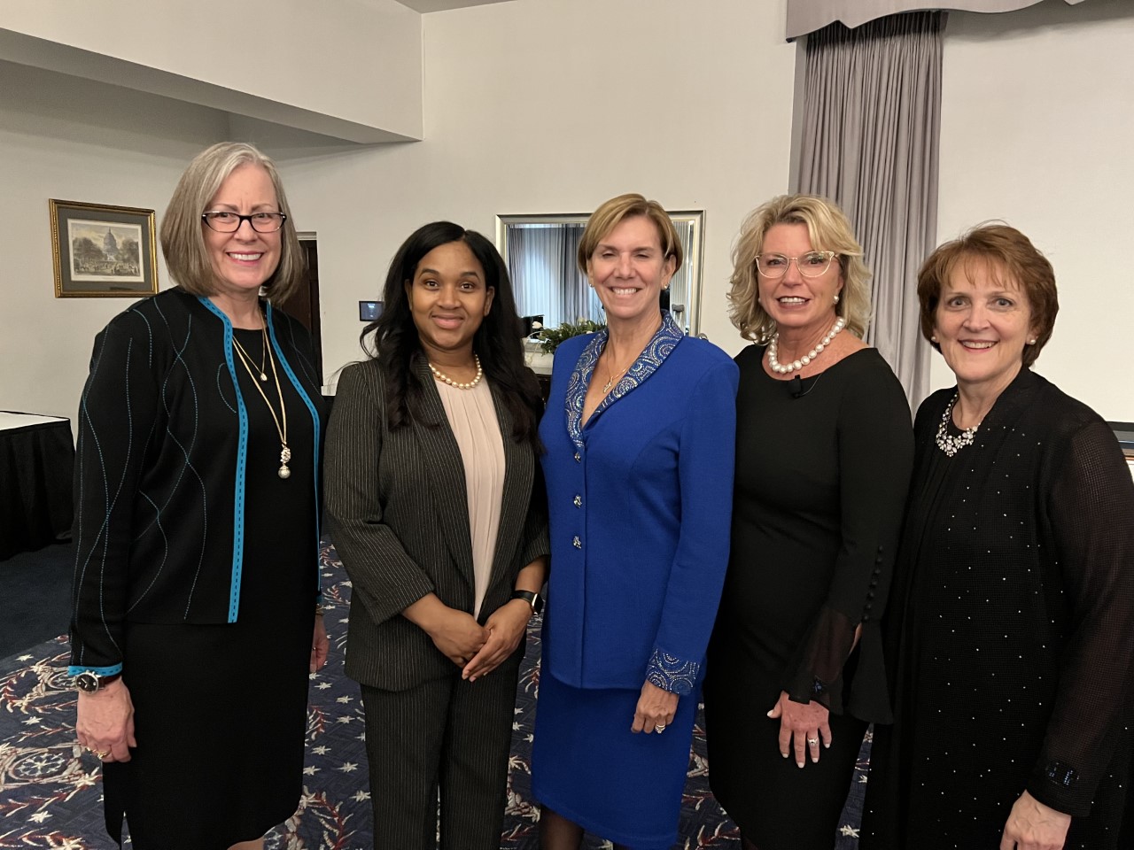 A group of women standing next to each other.