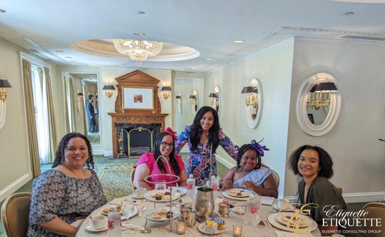 A group of women sitting at a table with food.