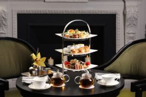 A table with three tiers of food on it.