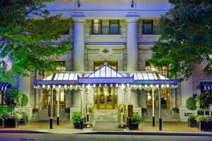 A large building with columns and a blue awning.