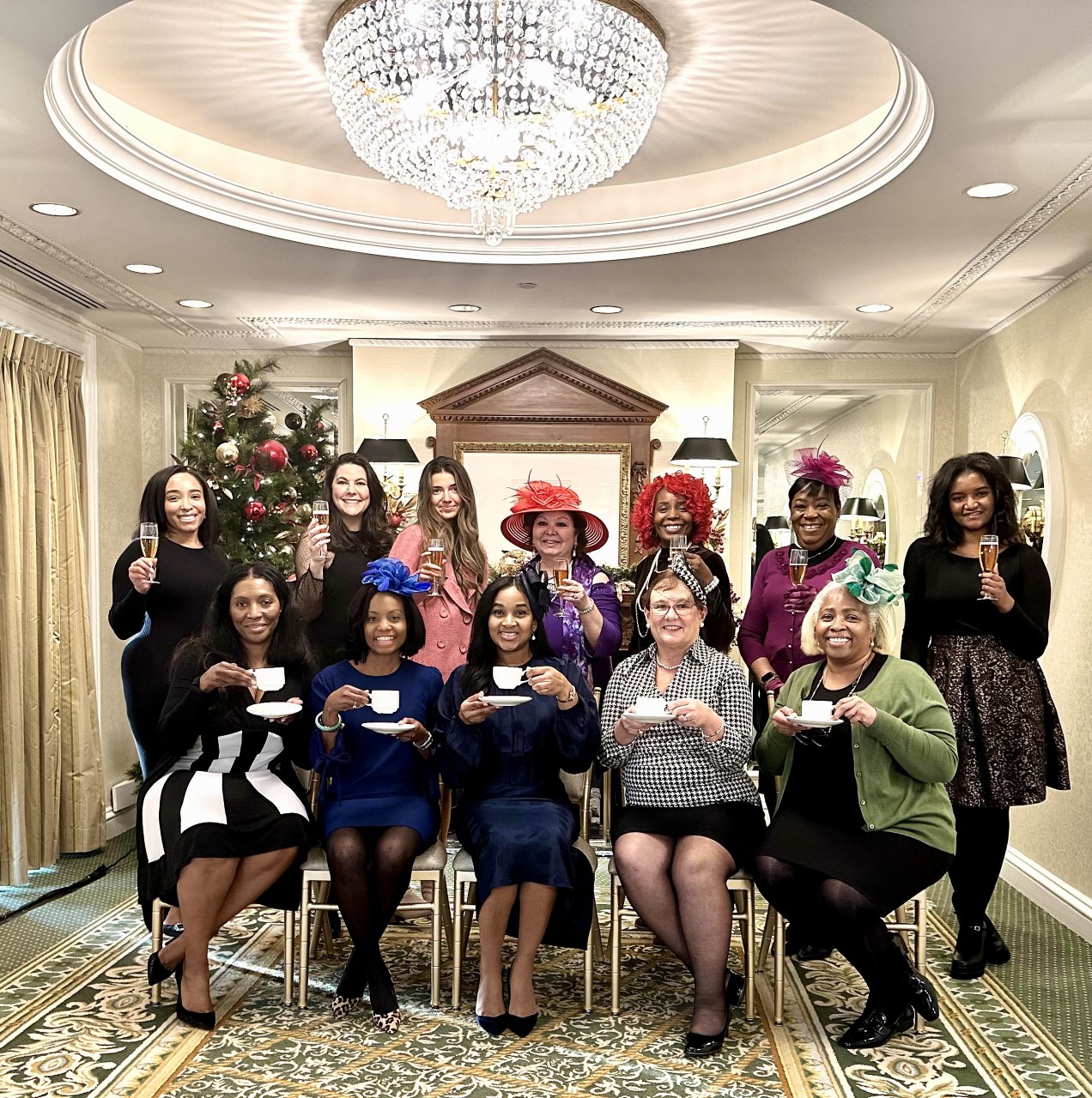 A group of women sitting in chairs holding cups.